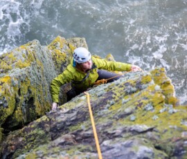 High above the sea seconding a trad route called Depth Charge Climber on the Aberdeen coast